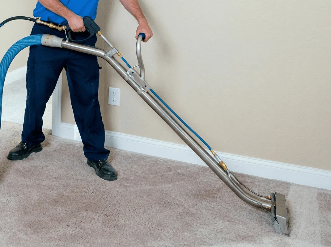 Professional operating a liquid removal machine on a carpeted floor in Stamford, CT